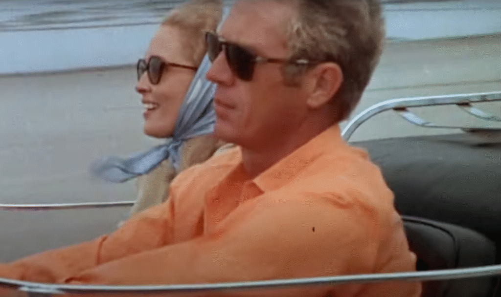 Screenshot from The Thomas Crown Affair (1968) showing steve mcqueen and faye dunaway in a beach buggy