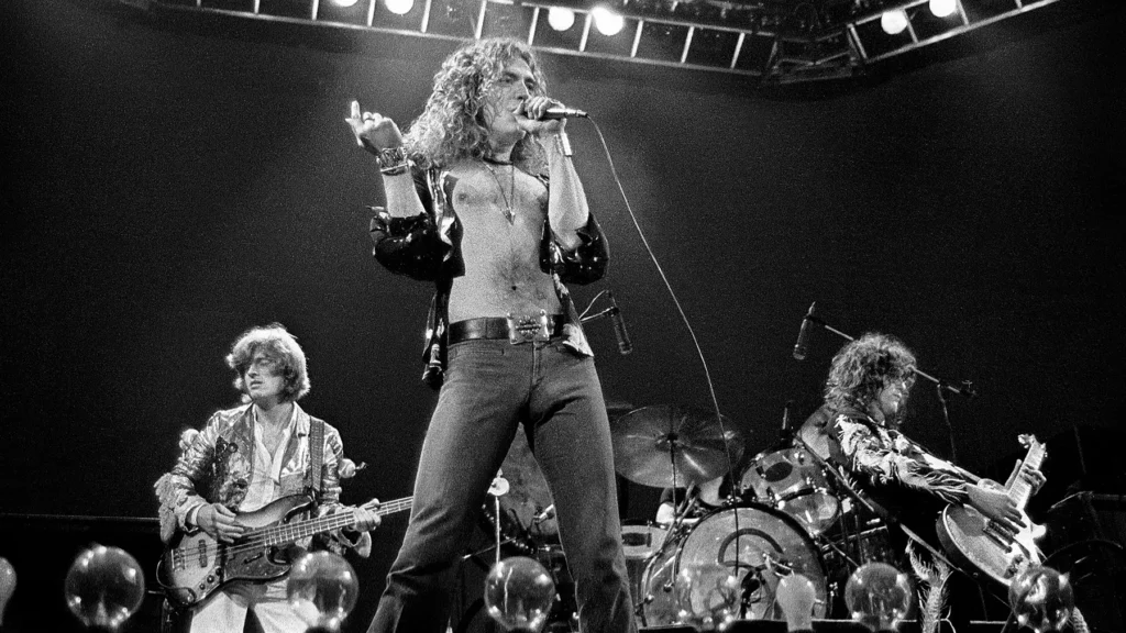 black and white image of led zeppelin live on stage in 1975